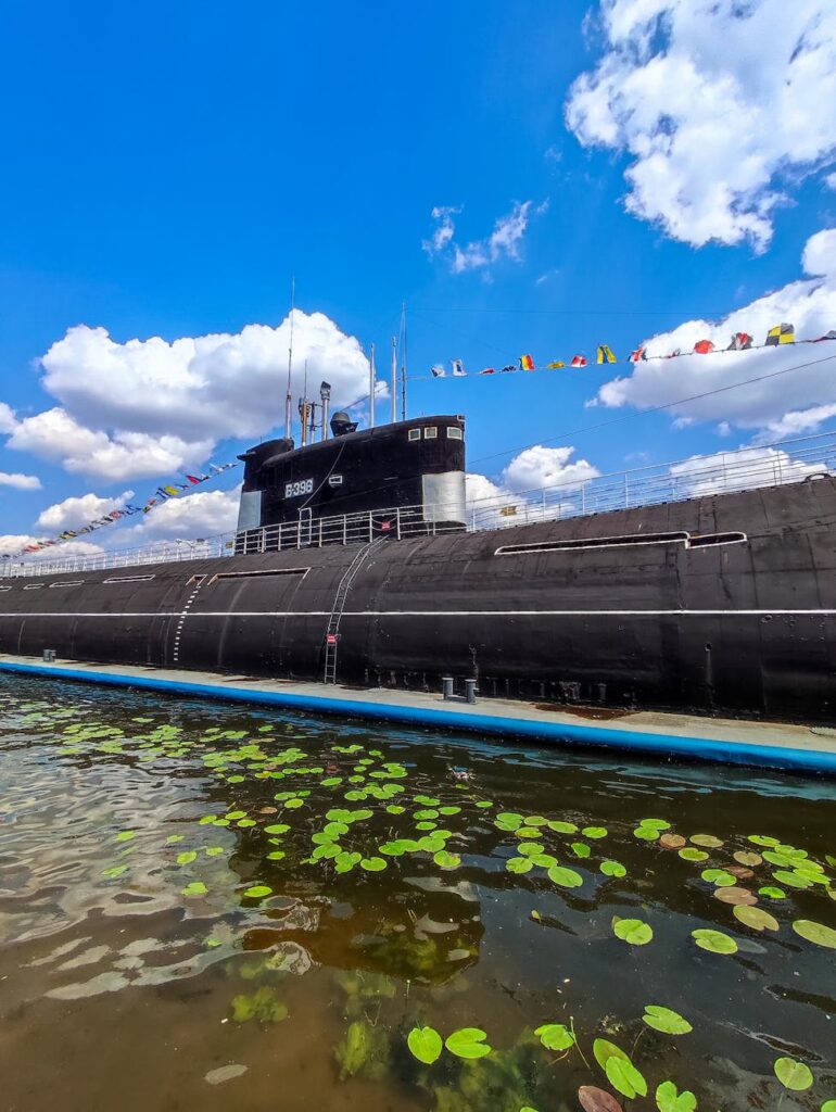 submarine decorated with flags moored at pier