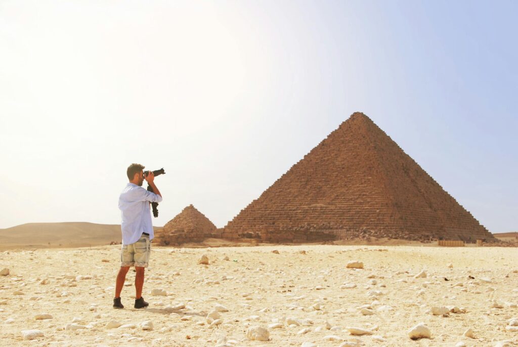 man taking photo of the great pyramid