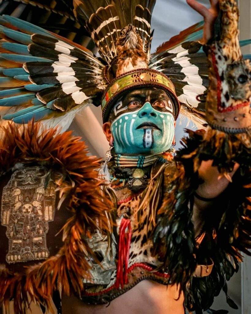vibrant traditional aztec dancer with feathered headdress
